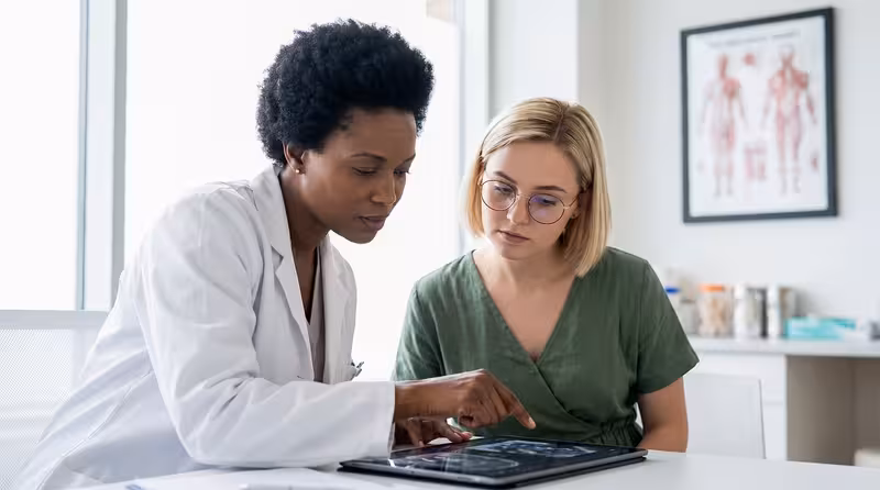 Why Many Patients Choose Private Microsuction Over Ear Syringing: A doctor and patient during a consultation Doctor and patient consultation for Why Many Patients Choose Private Microsuction Over Ear Syringing - Best Method To Head O...